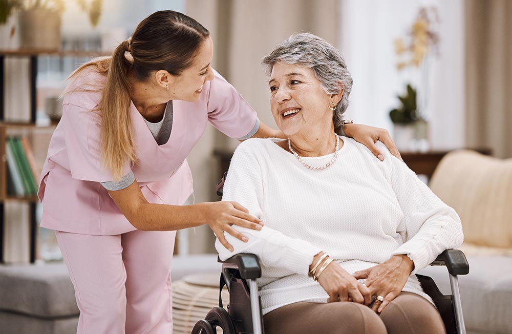 support worker wraps arm around disabled old woman