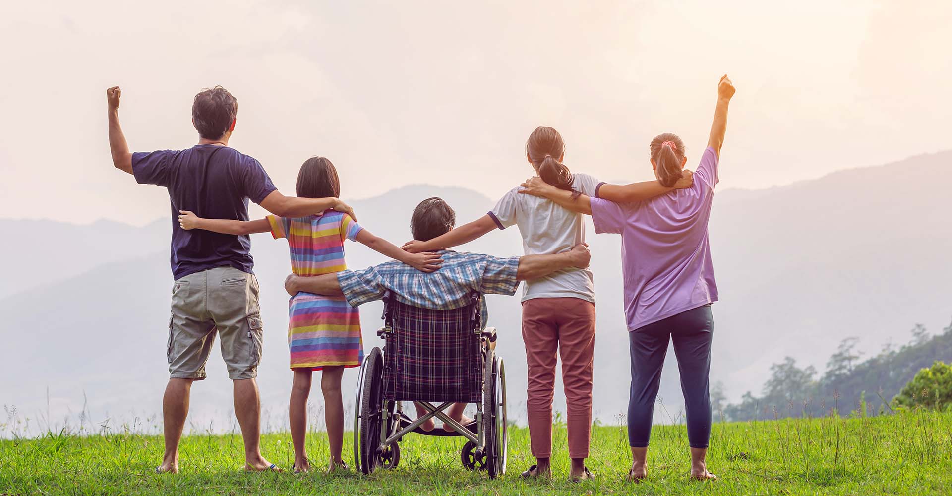 disabled person and other people raise arms in the air