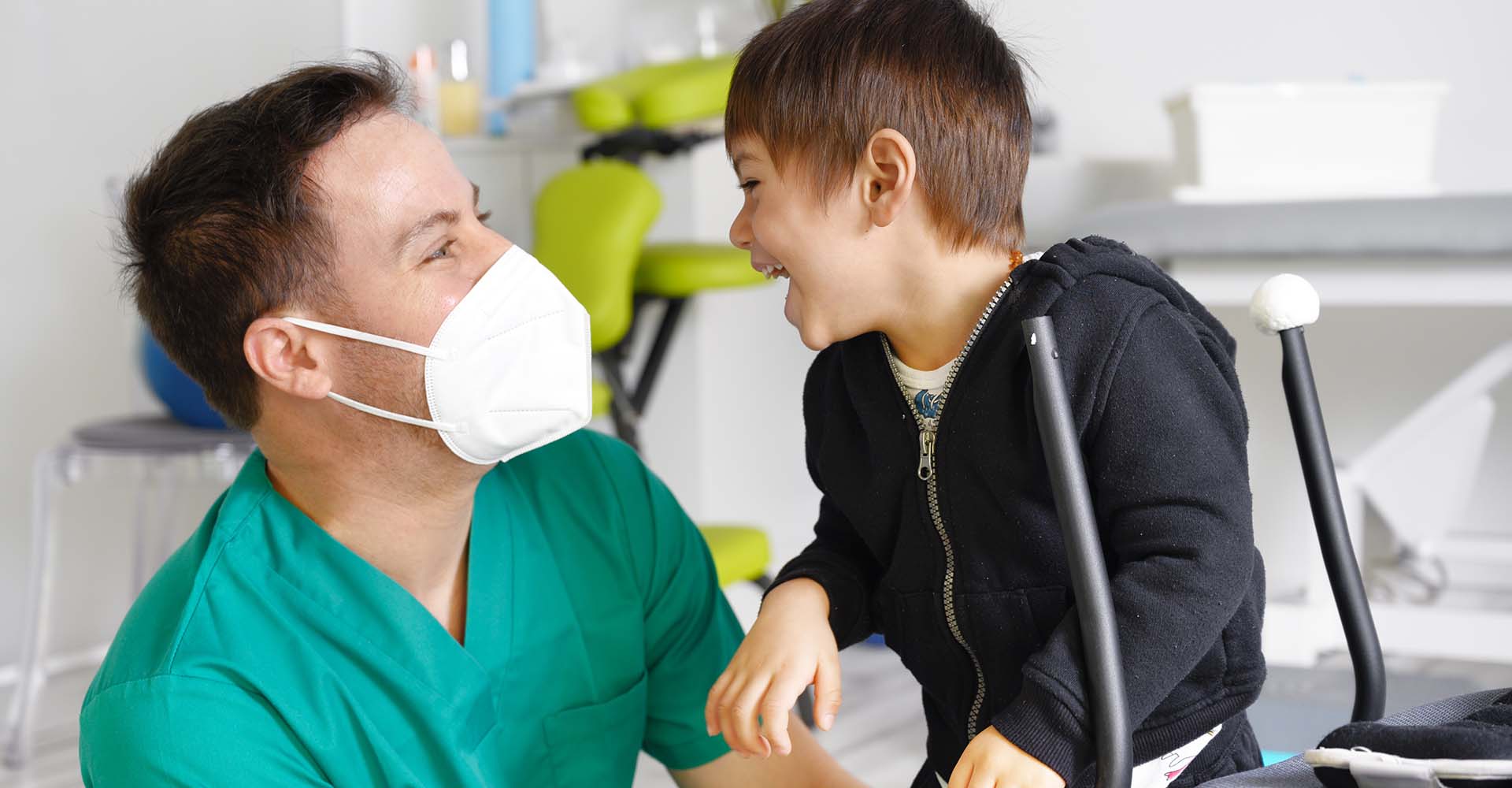 boy with intellectual disability smiles to support worker
