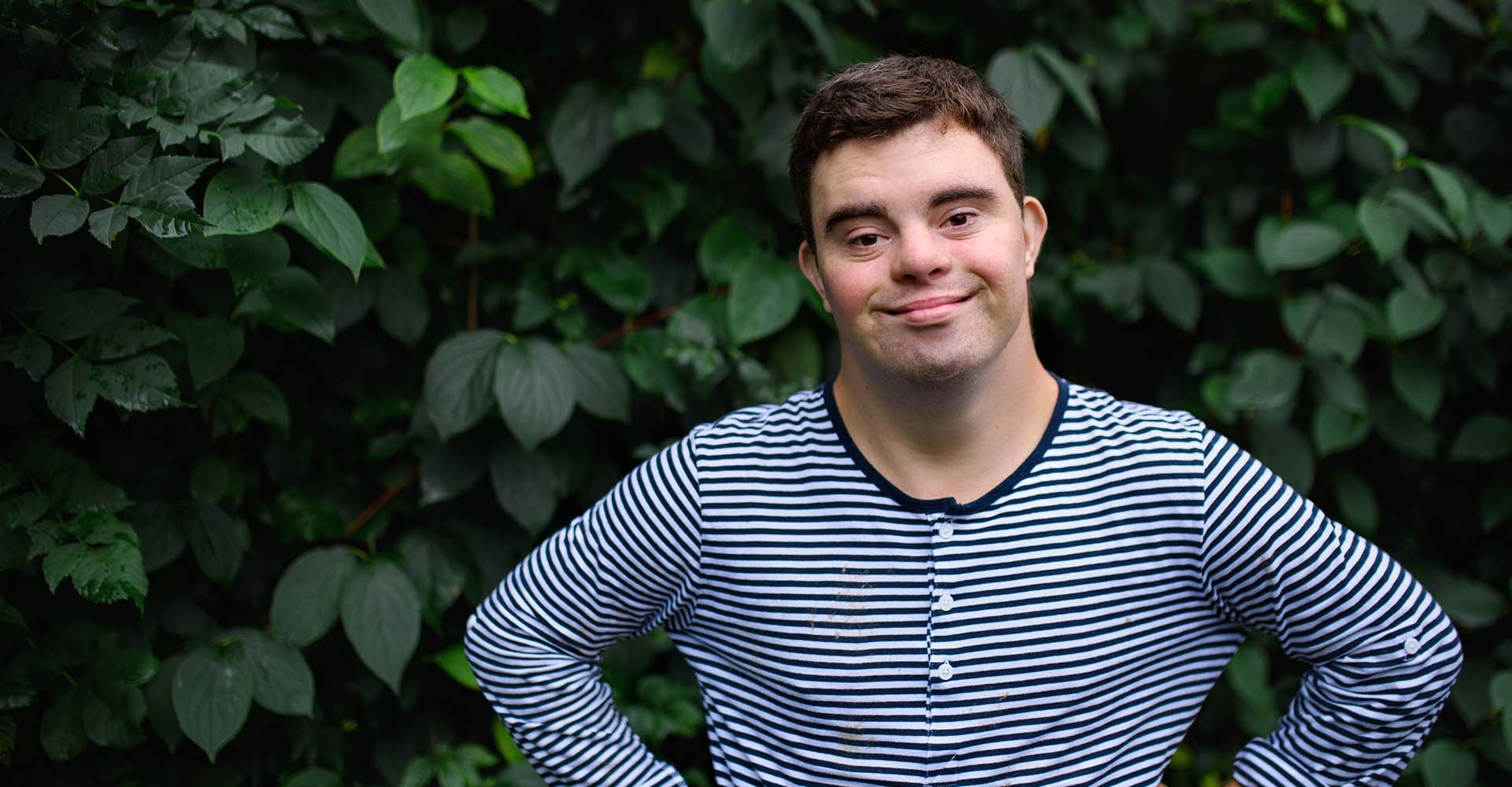 man with intellectual disability smiles in camera