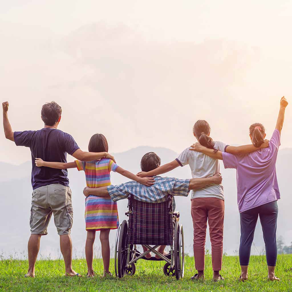 disabled person and other people raise arms in the air