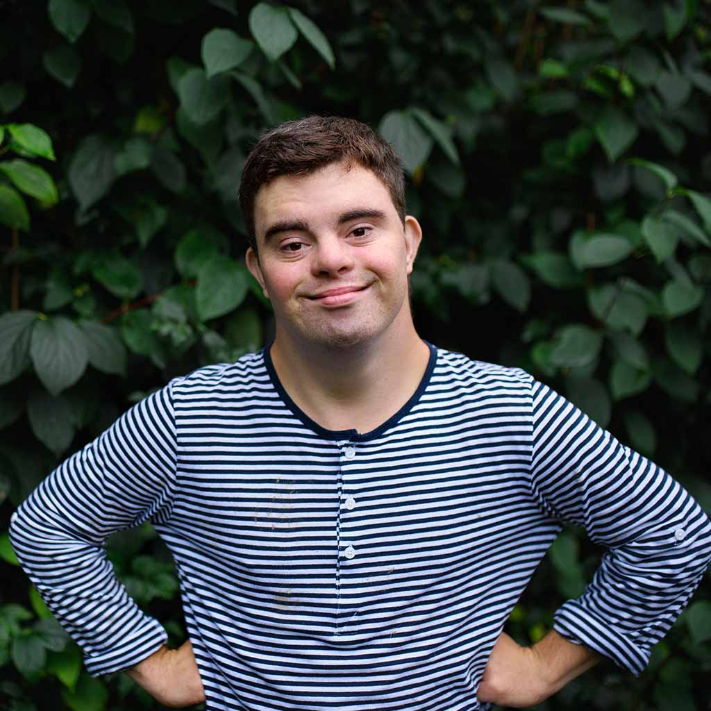 man with intellectual disability smiles in camera